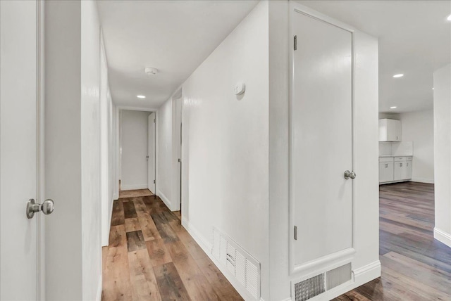 230 E Sycamore Dr, Hanford, CA 93230 - corridor featuring baseboards, visible vents, wood finished floors, and recessed lighting