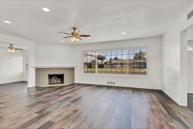 230 E Sycamore Dr, Hanford, CA 93230 - unfurnished living room with a ceiling fan, visible vents, wood finished floors, and baseboards