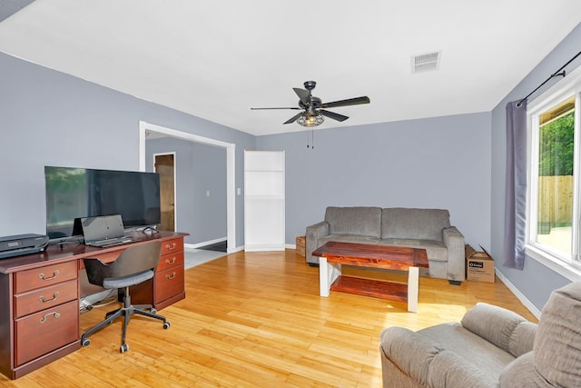 office space with visible vents, light wood-type flooring, and ceiling fan