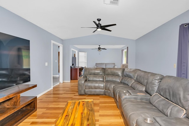 living room with light wood finished floors, ceiling fan, visible vents, baseboards, and lofted ceiling