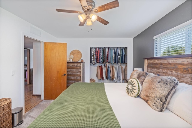carpeted bedroom with visible vents, a ceiling fan, and a closet