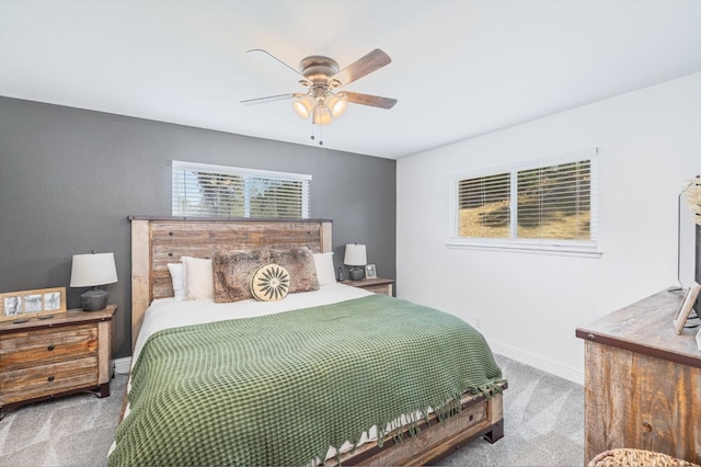 carpeted bedroom featuring a ceiling fan and baseboards