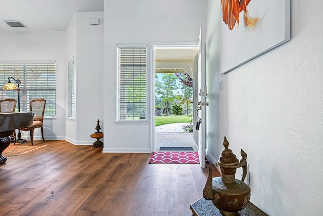 entryway featuring wood finished floors, visible vents, and baseboards