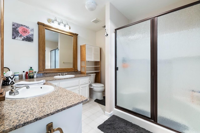 full bath featuring a shower stall, visible vents, toilet, tile patterned floors, and vanity