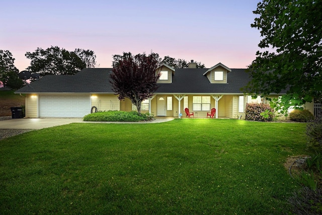cape cod house featuring concrete driveway, a chimney, covered porch, a front yard, and an attached garage