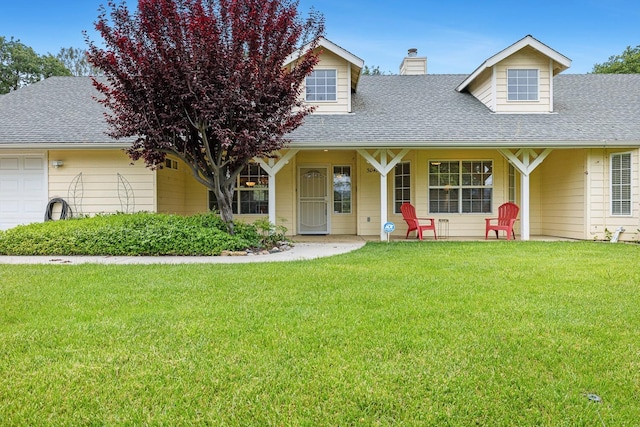 view of front of house featuring a porch, a front yard, a garage, a chimney, and roof with shingles