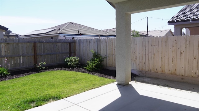 view of yard featuring fence and a patio