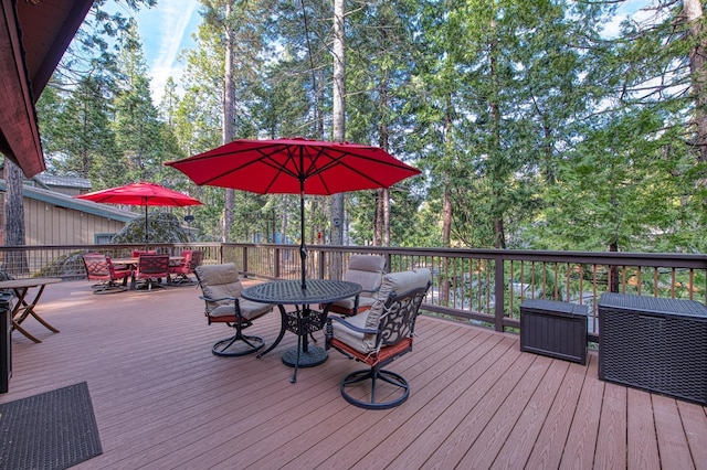 wooden terrace with outdoor dining area