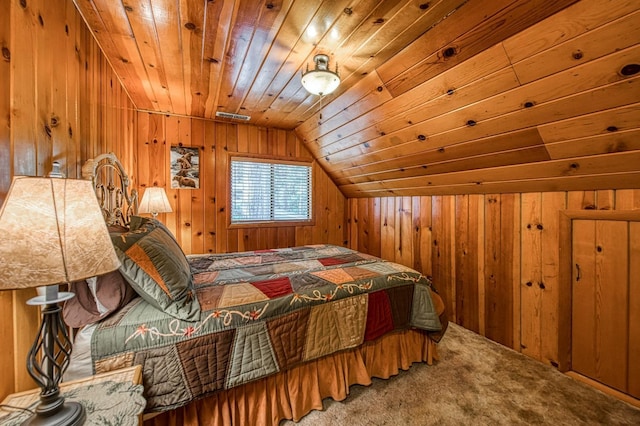 carpeted bedroom featuring wooden walls, visible vents, vaulted ceiling, and wood ceiling