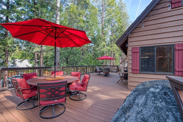 deck featuring outdoor dining area