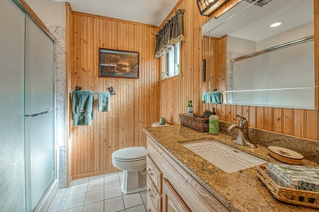 full bathroom with toilet, a stall shower, wood walls, and tile patterned floors