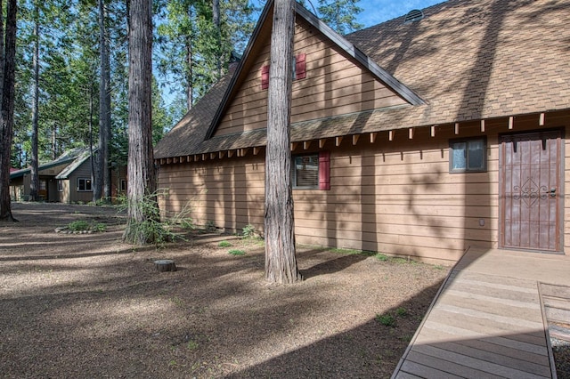 view of home's exterior featuring roof with shingles