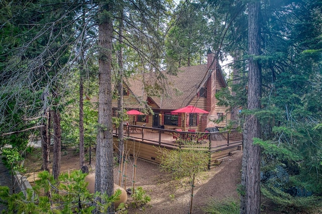back of house with a chimney, crawl space, and a wooden deck