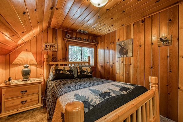 bedroom with lofted ceiling, carpet, wooden walls, and visible vents