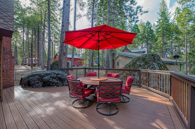 wooden terrace featuring outdoor dining area