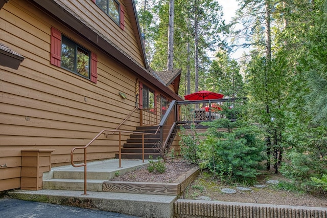 view of side of property with a deck and stairs