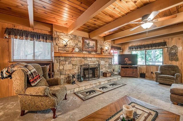 living room featuring beamed ceiling, wooden walls, carpet, and wood ceiling