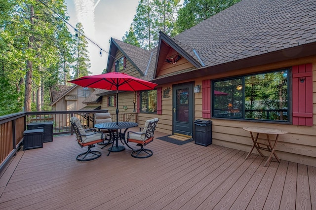 wooden deck featuring outdoor dining space