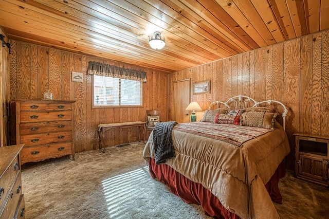 bedroom with wood ceiling, wood walls, and carpet floors