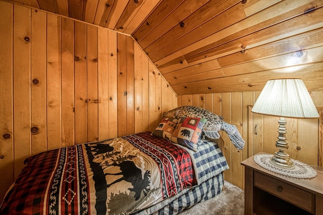 carpeted bedroom with wood ceiling, wooden walls, and vaulted ceiling