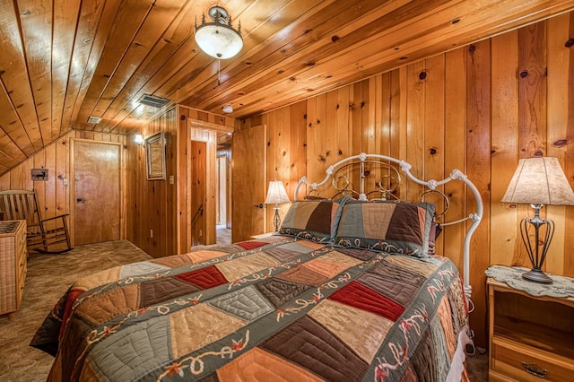 carpeted bedroom with wooden ceiling and wooden walls