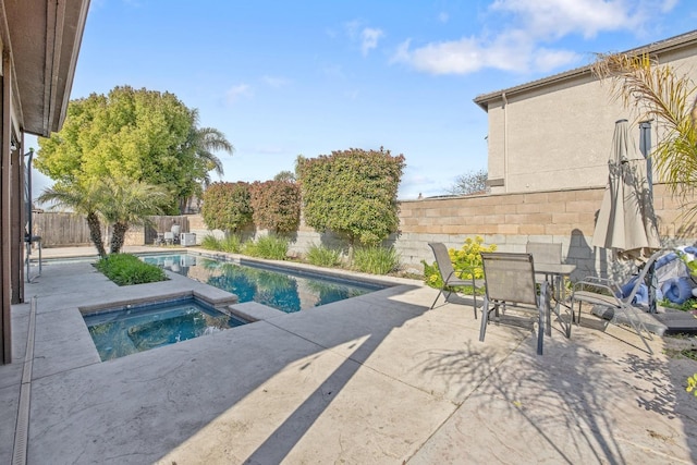view of swimming pool featuring an in ground hot tub, a fenced in pool, a patio area, outdoor dining area, and a fenced backyard