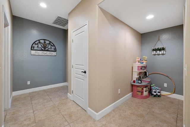 interior space featuring recessed lighting, visible vents, tile patterned floors, and baseboards