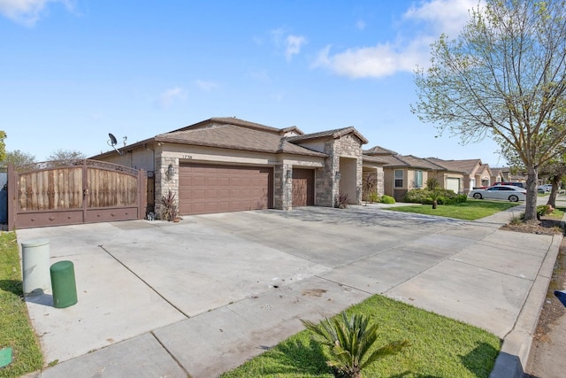 view of front of property with concrete driveway, stone siding, a gate, and a garage