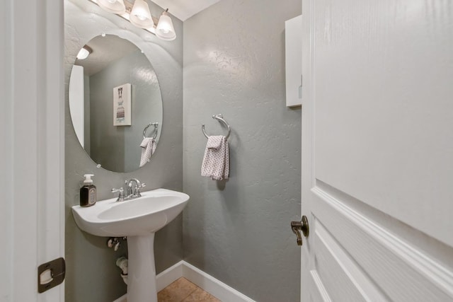 bathroom with tile patterned floors and baseboards