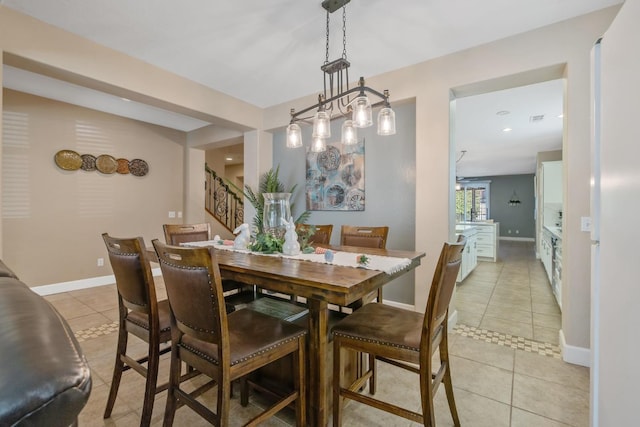 dining room featuring light tile patterned flooring, stairs, and baseboards