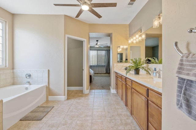 bathroom featuring a sink, ceiling fan, double vanity, visible vents, and a garden tub