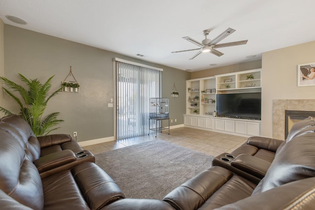 tiled living room with baseboards, visible vents, and ceiling fan