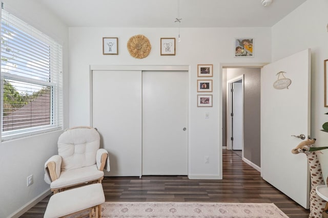 sitting room with wood finished floors and baseboards