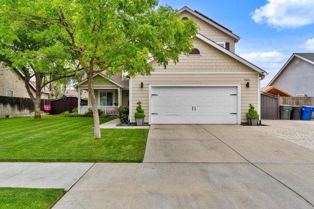 view of front of home featuring fence, concrete driveway, and a front yard