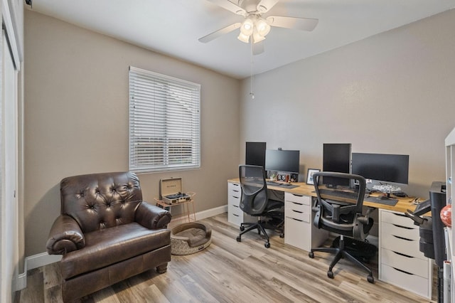 office area featuring baseboards, ceiling fan, and light wood-style floors