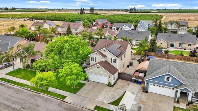 drone / aerial view featuring a residential view and a rural view