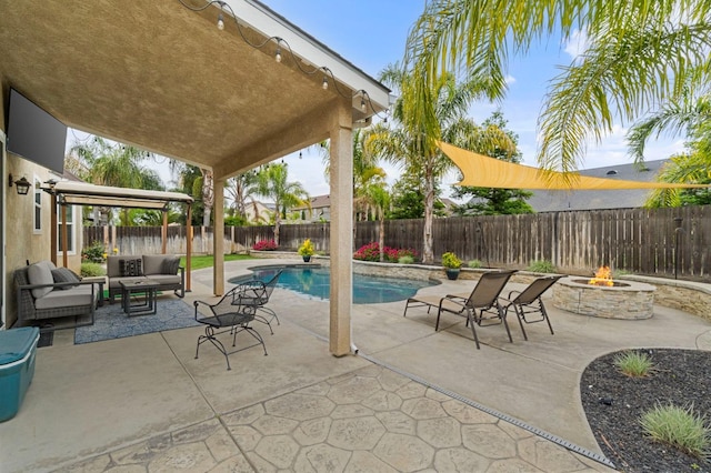 view of swimming pool featuring a fenced in pool, an outdoor living space with a fire pit, a patio, and a fenced backyard