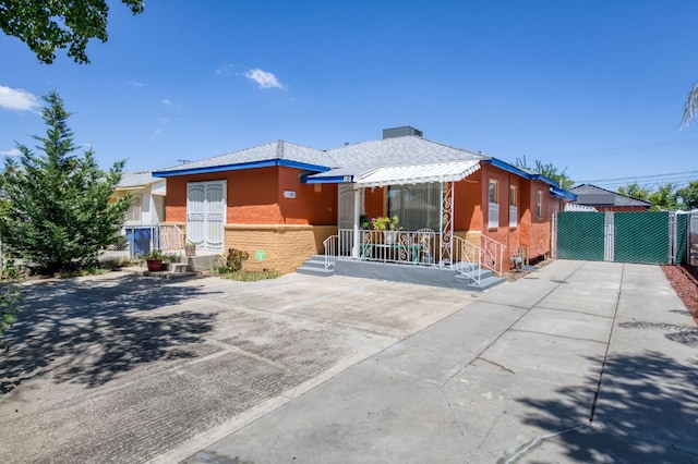 view of front of house featuring stucco siding and fence