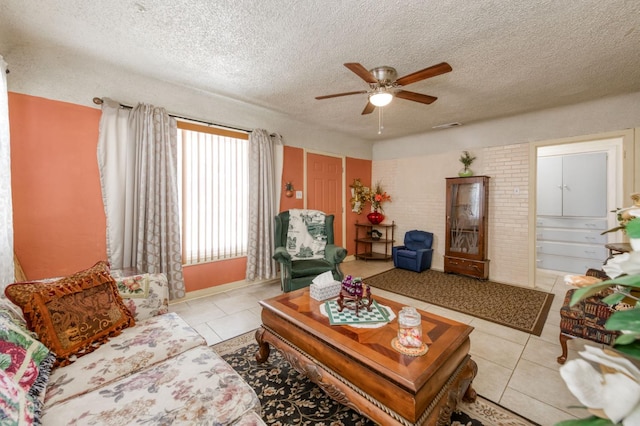 tiled living room featuring ceiling fan and a textured ceiling