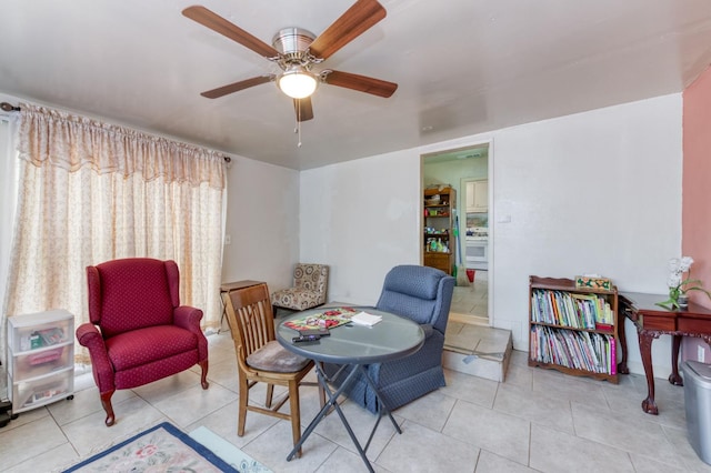 sitting room featuring a ceiling fan and tile patterned flooring