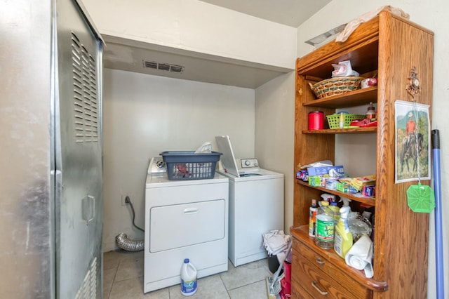laundry room with light tile patterned flooring and washer and dryer