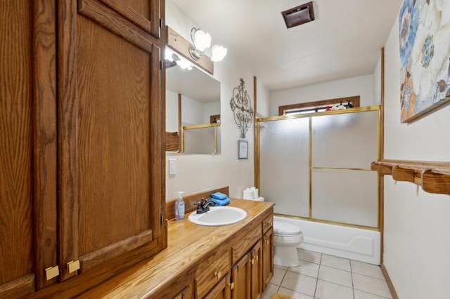 full bathroom featuring tile patterned floors, shower / bath combination with glass door, toilet, and vanity