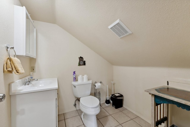 half bathroom with vanity, toilet, visible vents, a textured ceiling, and lofted ceiling