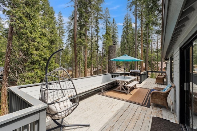 wooden terrace with outdoor dining space