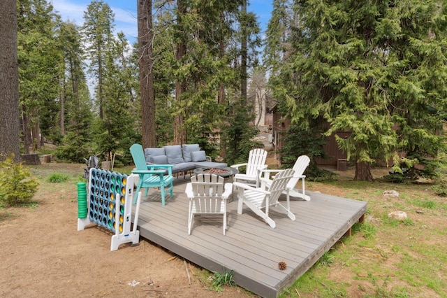 deck with an outdoor living space with a fire pit
