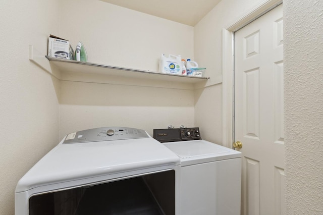 washroom featuring separate washer and dryer and laundry area