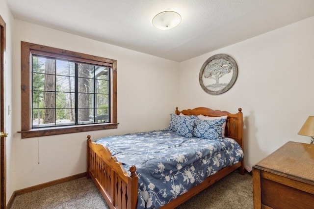 bedroom with carpet flooring and baseboards