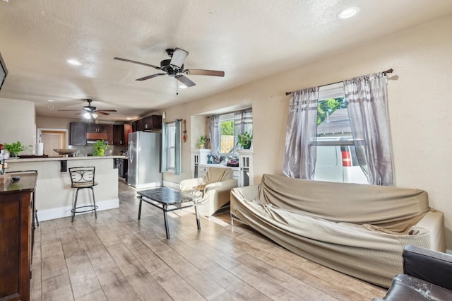 555 S Sierra Vista Ave, Fresno, CA 93702 - living area with a textured ceiling, baseboards, light wood-type flooring, recessed lighting, and a ceiling fan