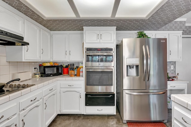 167 W Quincy Ave, Fresno, CA 93711 - kitchen with tile counters, stainless steel appliances, a warming drawer, and white cabinets