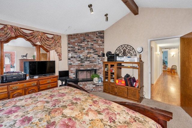167 W Quincy Ave, Fresno, CA 93711 - carpeted bedroom with lofted ceiling with beams and a brick fireplace